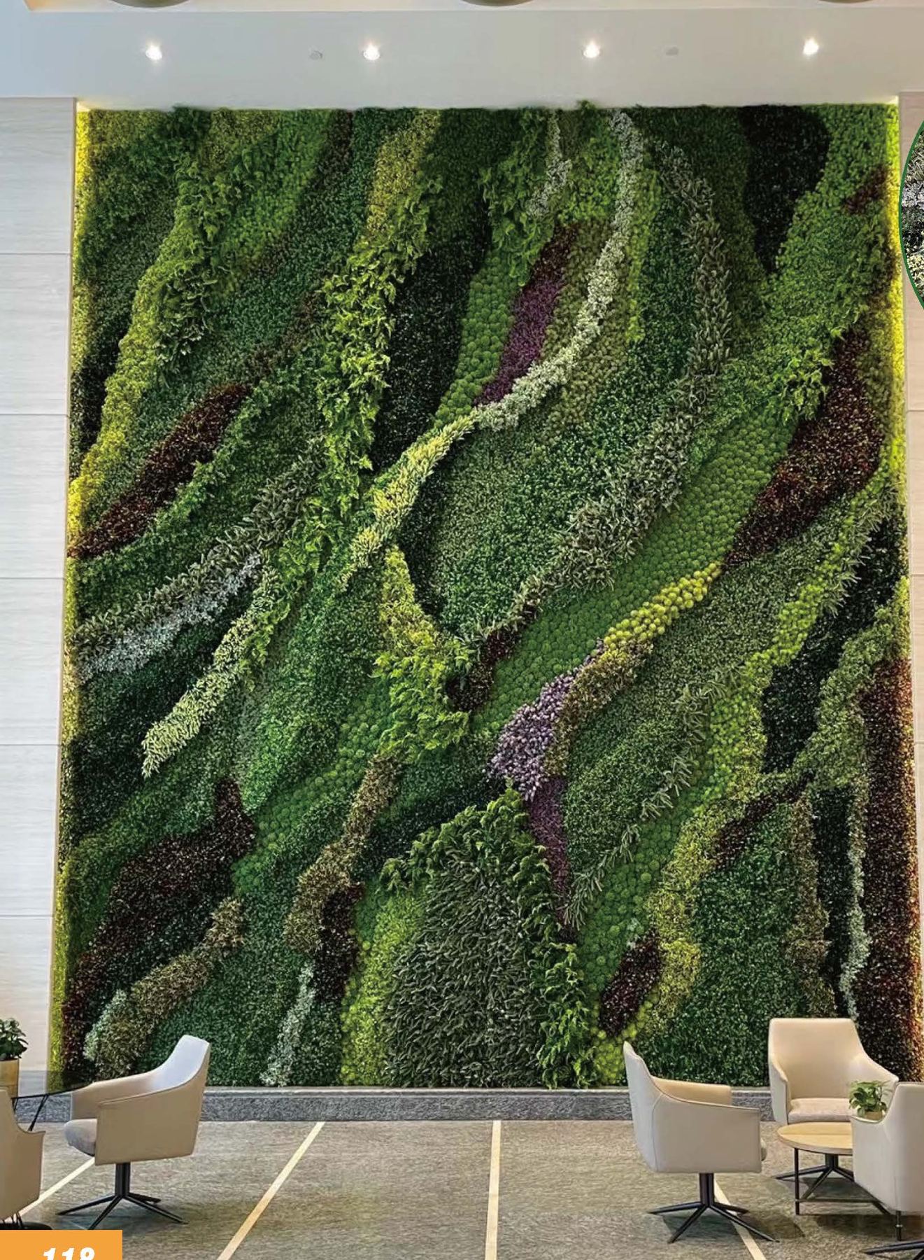 A floor-to-ceiling artificial green wall with flowing moss patterns in a lobby